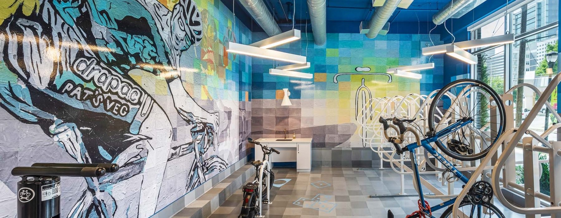 a room with bikes and a wall with graffiti